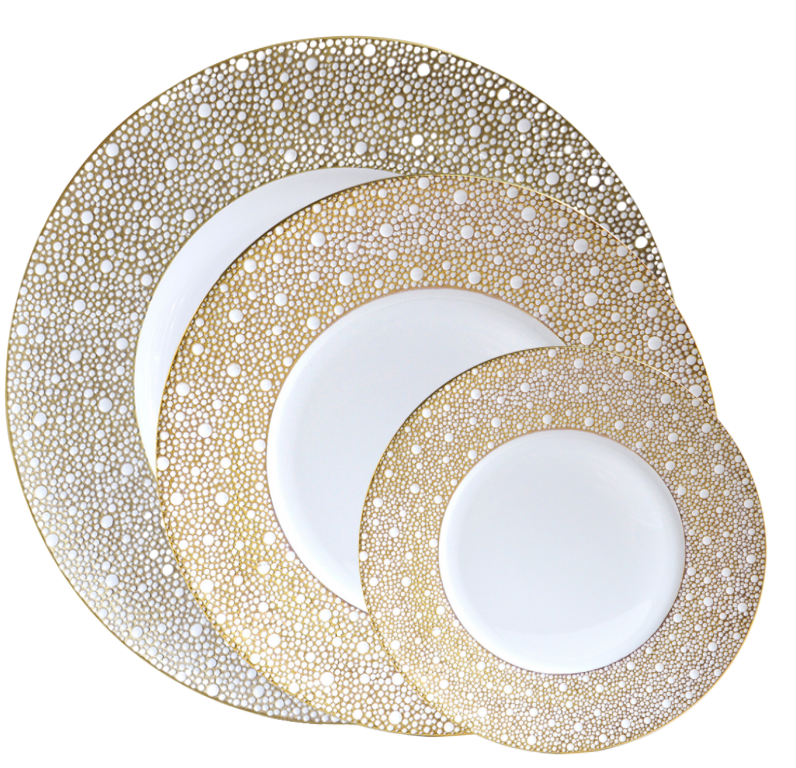 Three round plates from Bernardaud's Ecume Dinnerware Mordore collection display white centers with gold dotted rims, arranged slightly overlapping on a white background.