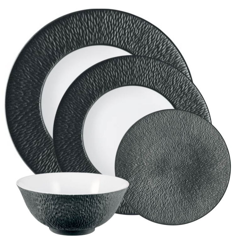 The Raynaud Mineral Irise Dinnerware - Black set includes two large plates, one small plate, and a bowl, all featuring a black textured exterior and smooth white interior for a stylish modern look.