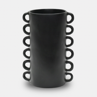 The Tina Frey Loopy Resin Vase Black is a tall, cylindrical vase with a matte finish and six evenly spaced loop handles on each side, shown against a plain white background.