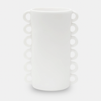 The Loopy Resin Vase White by Tina Frey is a tall, cylindrical handmade vase with two vertical rows of small circular handles on opposite sides. Displayed against a plain light gray background.