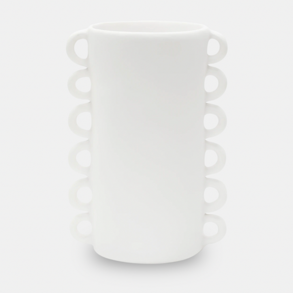 The Loopy Resin Vase White by Tina Frey is a tall, cylindrical handmade vase with two vertical rows of small circular handles on opposite sides. Displayed against a plain light gray background.