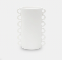 The Loopy Resin Vase White by Tina Frey is a handmade resin vase with a cylindrical shape, scalloped edge, and distinctive looped handles on each side.