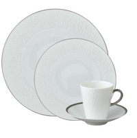 The Raynaud Mineral Irise Dinnerware Platinum set features elegant white Limoges porcelain with a subtle texture and platinum trim, including a dinner plate, salad plate, bread plate, and teacup with saucer.