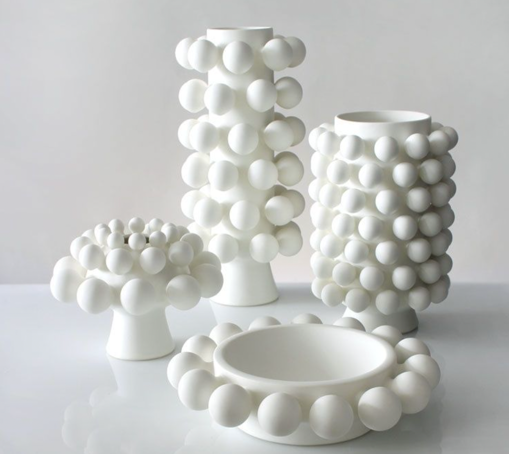 The KleinReid Nimbus Dome Vase Onyx features a glossy white surface with raised, rounded bubble patterns, showcasing the brand's signature handmade porcelain craftsmanship against a neutral background.