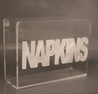 The Eye Candy Acrylic Napkin Holder features a modern clear design with "NAPKINS" in bold, white letters across the front.
