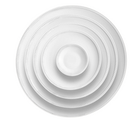 Five Soie Tressée White Dinnerware plates by L'Objet are stacked concentrically, viewed from above. Each Limoges porcelain plate features a subtle braided border, set against a plain white background.