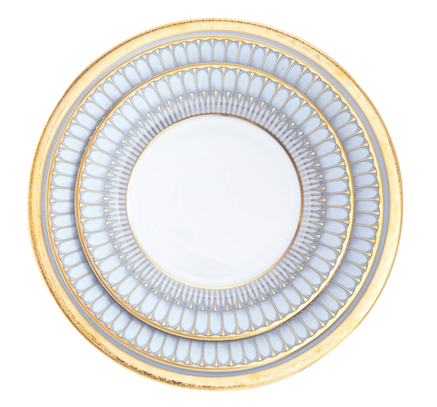 The Philippe Deshoulieres Arcades Gold Dinnerware round white ceramic plate features intricate blue and gold arches and two wide decorative gold rims.