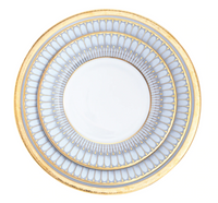 The Philippe Deshoulieres Arcades Gold Dinnerware round white ceramic plate features intricate blue and gold arches and two wide decorative gold rims.