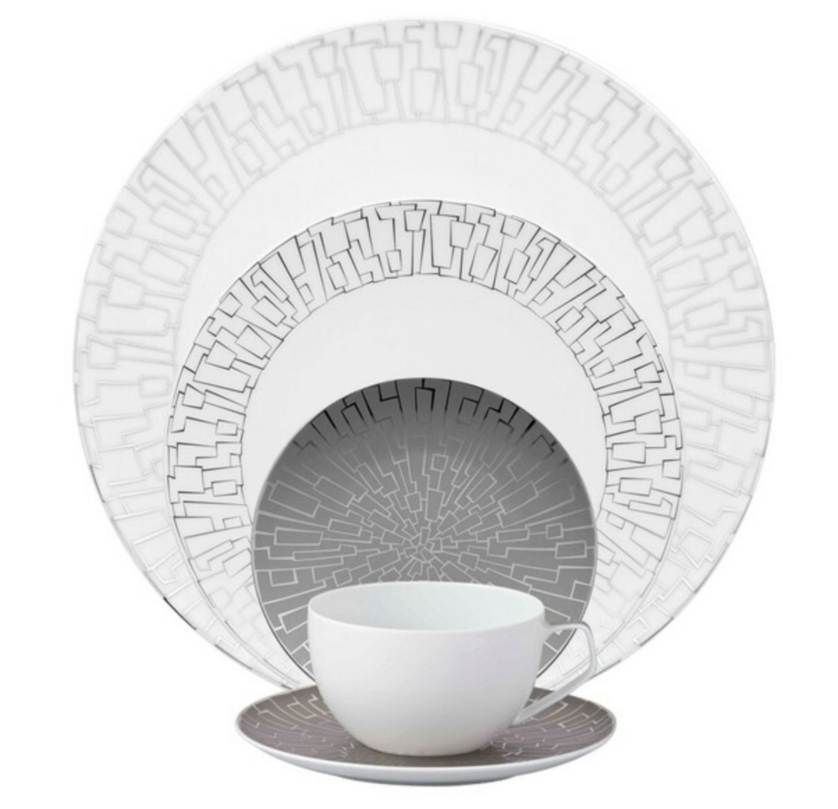The Rosenthal Skin Platinum TAC 02 Dinnerware features modern geometric silver and gray patterns with platinum accents. The set includes a dinner plate, salad plate, bowl, cup, and saucer arranged in a nested display.
