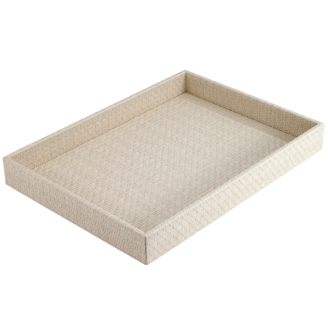 The Bodrum Wicker Rectangle Tray Cream has a simple, textured design with raised edges and an open top. Shown on a white background, this phthalate-free tray offers classic style in lightweight beige wicker.