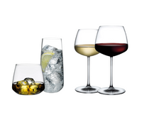 Four glasses from the Nude Glassware Mirage Barware collection—brown liquor on ice, clear drink with lemon, white wine, and red wine—are crafted from lead-free crystal and displayed on a white background.