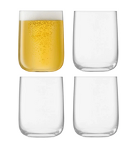 Four Borough Barware glasses by LSA are arranged in a grid; the top left glass holds a yellow fizzy drink with foam, while the other three are empty—an elegant set of stemless glasses for any barware collection.