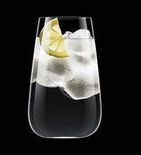 A Luigi Bormioli Talismano Bar Collection glass, filled with ice, water, and a lemon wedge, is set against a solid black background.