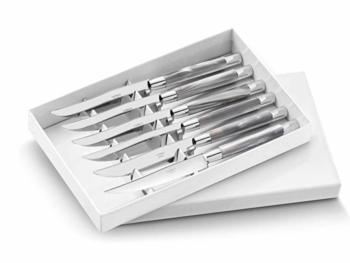 The Capdeco Conty Steak Knives Set of 6 features French-made stainless steel knives with serrated blades, neatly arranged in a white box with a partially open lid.