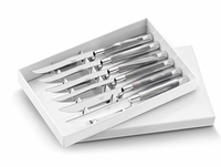 The Capdeco Conty Steak Knives Set of 6 features French-made stainless steel knives with serrated blades, neatly arranged in a white box with a partially open lid.