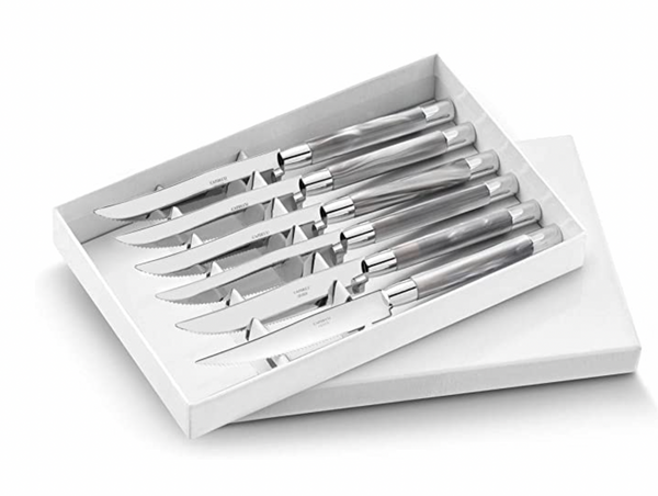 The Capdeco Conty Steak Knives Set of 6 features French-made stainless steel knives with serrated blades, neatly arranged in a white box with a partially open lid.