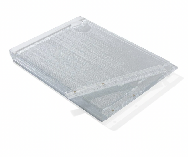 The Apeloig Collection Metallic Silver Acrylic Challah Board features a textured acrylic surface and metal hinge clip, perfectly angled on a white background—ideal as a modern challah board or thoughtful gift.