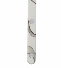 A close-up of the Sabre Bistrot Dune Butter Spreader Ivory shows its white surface with brown wavy lines, two clear round bumps resembling fasteners, and a smooth, slightly curved bottom edge—an elegant French flatware design.