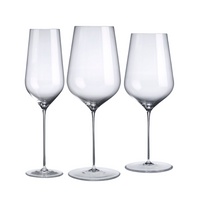 Three clear, lead-free crystal wine glasses from Nude Glassware's Stem Zero Barware collection are displayed side by side in various shapes and sizes against a white background.
