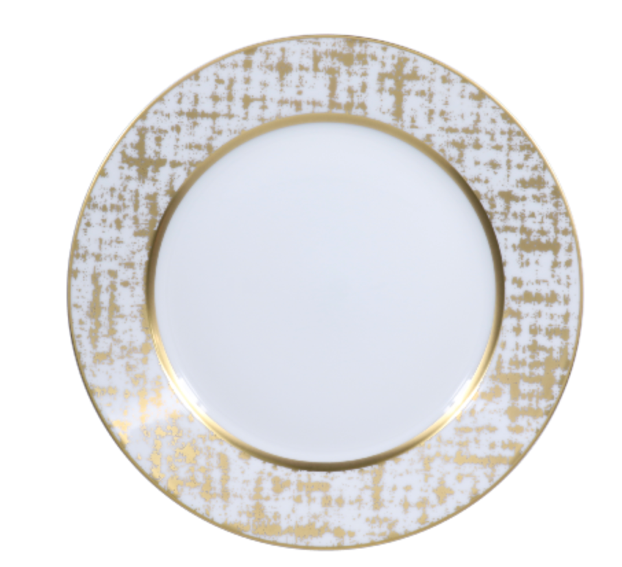 The Tweed White & Gold Dinnerware by Royal Limoges features a round white plate with a wide, textured gold and white rim in an abstract grid pattern, a solid gold inner band, and a plain white center—an elegant handcrafted piece.