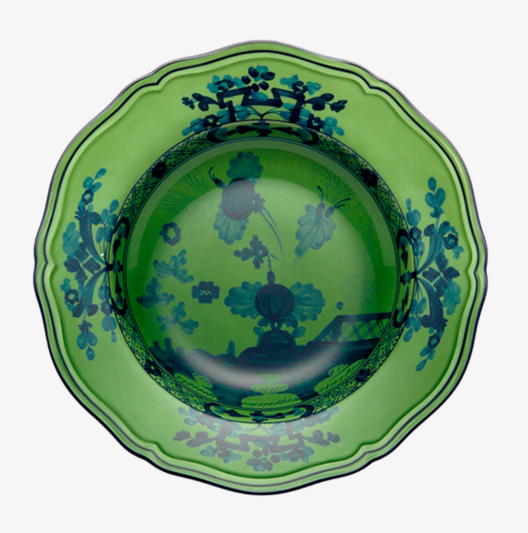 A green ceramic bowl with scalloped edges, adorned with blue floral and geometric interior patterns. The Oriente Italiano Dinnerware Malachite by Ginori 1735 showcases ornate, vintage Italian elegance.