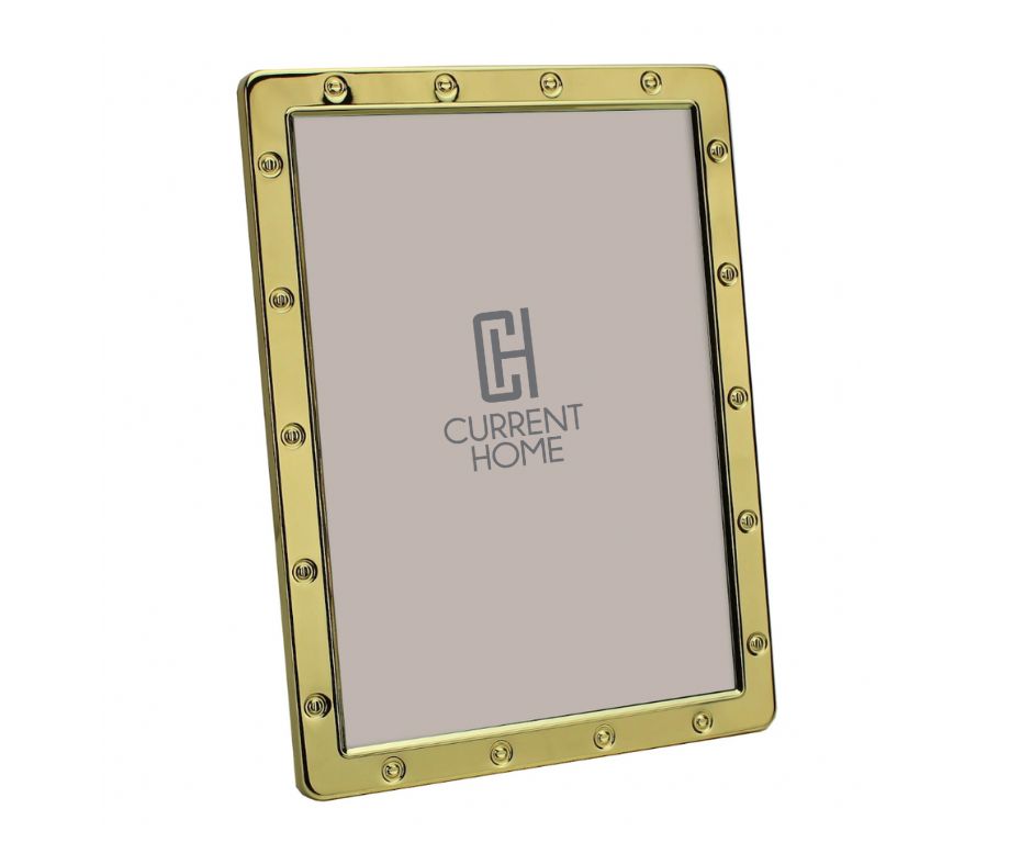 The Addison Ross Locket Frame Gold features a gold rectangular design with rounded corners and decorative rivets, displaying a placeholder image with the Current Home logo. It stands at an angle and comes in an elegant gift box.