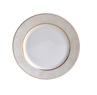 The Bernardaud Sauvage Gold Dinnerware features a white Limoges porcelain plate with a textured, light gold and white snakeskin-patterned rim and a thin gold band, displayed from above on a white background.