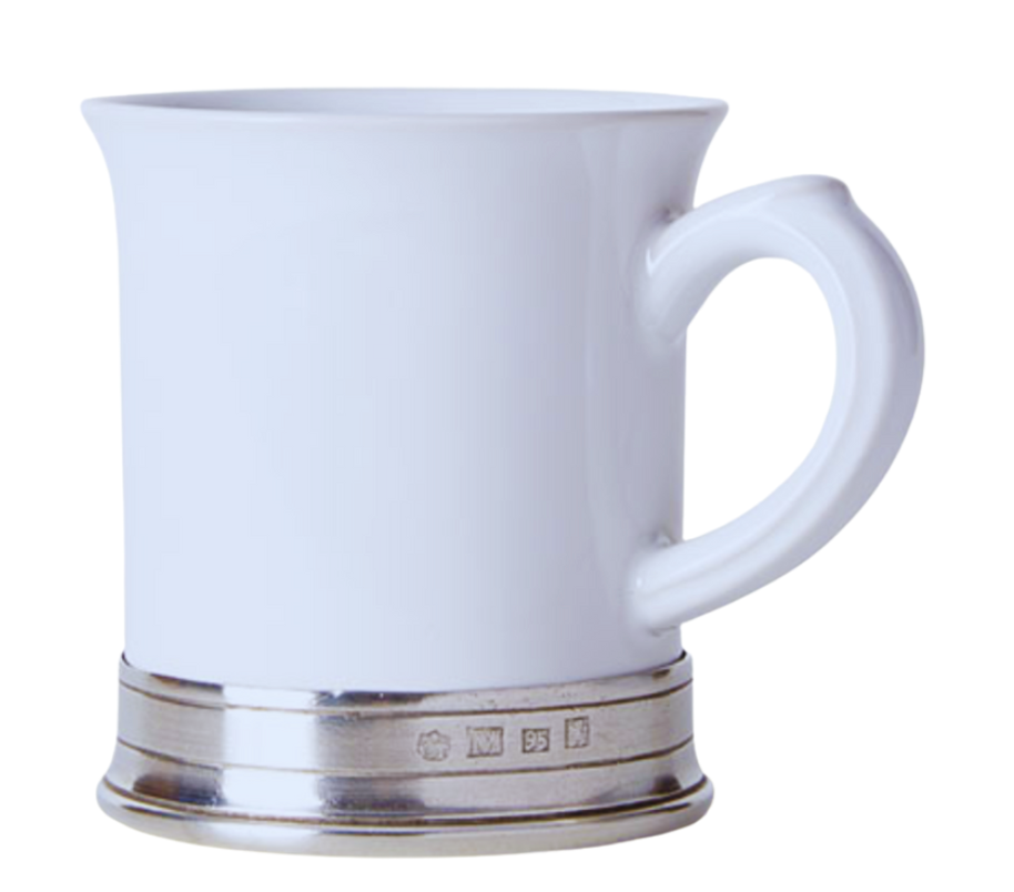 The MATCH Convivio by MATCH is a white ceramic mug with a flared rim, large handle, and a metallic silver band with engraved markings at the base, inspired by Italian dinnerware. The background is plain white.