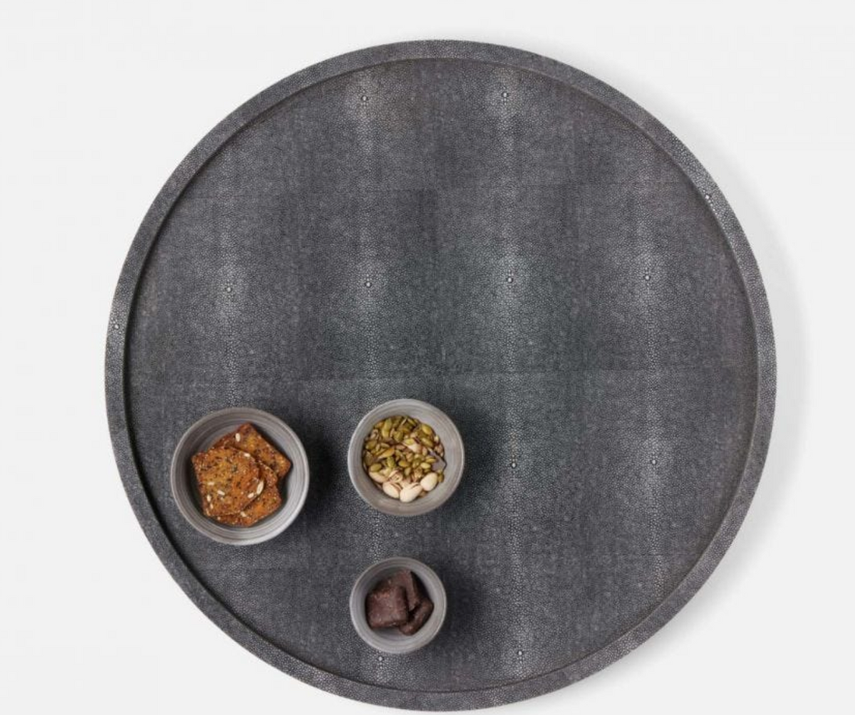 The Calvin Faux Shagreen Lazy Susan by Blue Pheasant in grey rotates to display snacks like crackers, mixed seeds and nuts, and dark chocolate, making it an entertaining essential for any tabletop centerpiece.