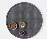The Calvin Faux Shagreen Lazy Susan by Blue Pheasant in grey rotates to display snacks like crackers, mixed seeds and nuts, and dark chocolate, making it an entertaining essential for any tabletop centerpiece.