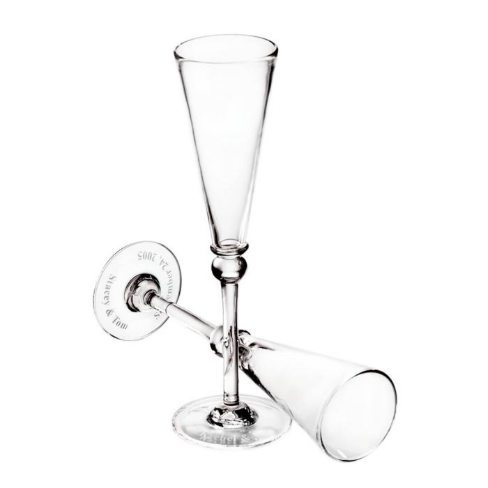 The Simon Pearce Hartland Flute Set of 2 features two clear handmade glasses, one upright and one horizontal with interlocked stems, displayed empty on a white background—an elegant and memorable wedding gift.