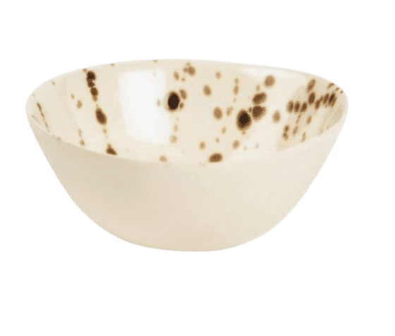 The Delaney Bronze Splatter Dinnerware by Blue Pheasant features a cream stoneware bowl with brown speckles and a bronze splatter finish, displayed against a white background.