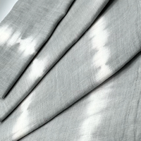 Close-up of Whigstock Studio’s Hand Dyed Linen Napkin Set of 4 in Pebble—gray napkins with soft white streaks and a textured, woven look.