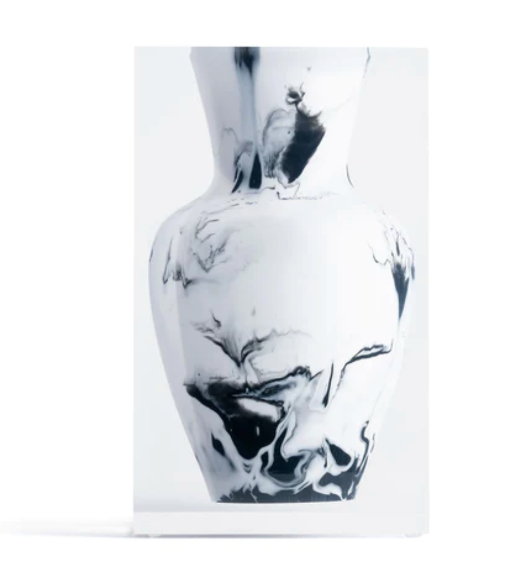 A rectangular clear block encases a piece from the JR William Lucite Vase Collection, showcasing black abstract marbling, photographed on a plain white background for a contemporary effect.