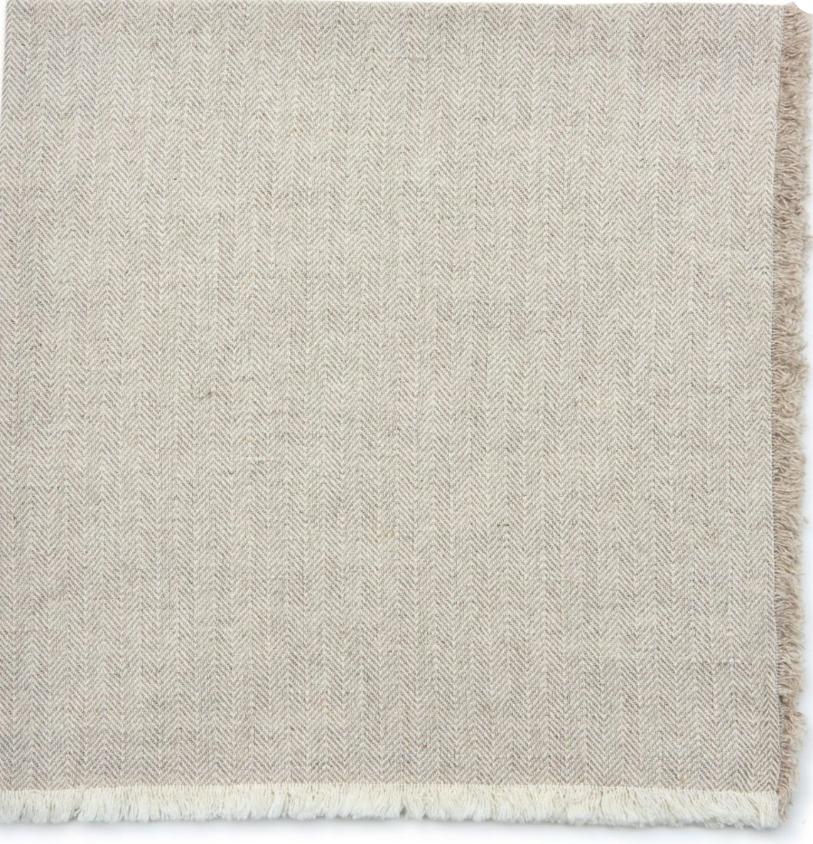 The Deborah Rhodes Herringbone Fringe Napkin Flax Set of 4 features beige napkins with a textured, soft feel and short white fringe along the edge—ideal for those seeking elegant, flax table accessories.