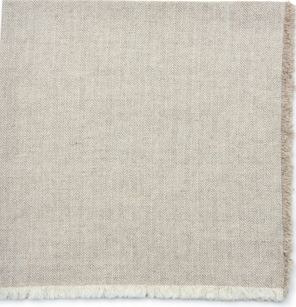 The Deborah Rhodes Herringbone Fringe Napkin Flax Set of 4 features beige napkins with a textured, soft feel and short white fringe along the edge—ideal for those seeking elegant, flax table accessories.