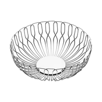 The Georg Jensen Alfredo Bread Basket Large features a modern, open stainless steel wire design and solid circular base—ideal for serving bread at dinner parties. Shown empty against a black background.