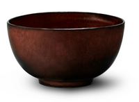 The L'Objet Terra Wine Dinnerware bowl is a dark brown, round piece with a slightly textured surface, wide opening, and small base, showcasing unique artisanal charm against a white background.