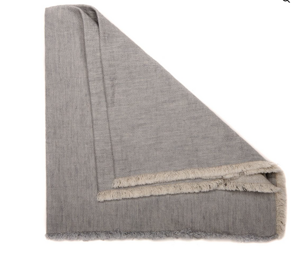 A set of four Deborah Rhodes Woven Washed Fringe Napkins in light gray, featuring soft, folded fabric and fringed edges, displayed on a white background.