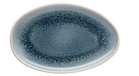 The Rosenthal Junto Aquamarine Dinnerware oval plate features a blue speckled reactive glaze interior with a smooth white rim. Made of stoneware, it's dishwasher and microwave safe. Plate is empty on a plain white background.