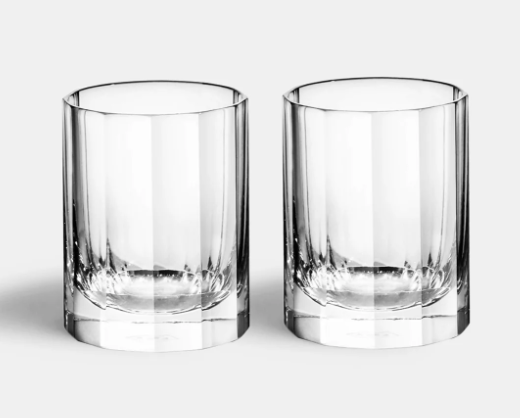 The Richard Brendon Fluted Shot Glass Set of 2 features mouth-blown, cylindrical shot glasses with thick bases, set side by side on a light gray background—an elegant addition to any barware collection.