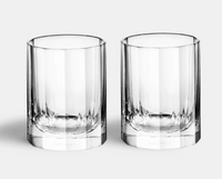 The Richard Brendon Fluted Shot Glass Set of 2 features mouth-blown, cylindrical shot glasses with thick bases, set side by side on a light gray background—an elegant addition to any barware collection.