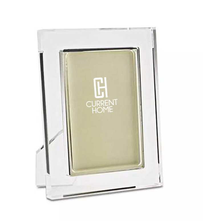 A chic Matte Lip Frame Clear by Tizo displays a blank beige insert with the white Current Home logo centered. The frame stands upright with a visible rear support.