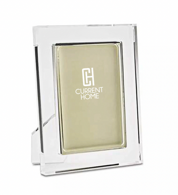 A chic Matte Lip Frame Clear by Tizo displays a blank beige insert with the white Current Home logo centered. The frame stands upright with a visible rear support.