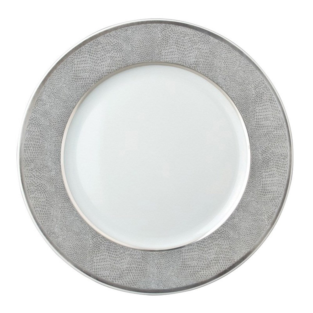 The Bernardaud Sauvage Grey & Platinum plate features a round white center, a snake skin embossed silver-gray border, and shiny platinum trim along the edge. The center is plain and unadorned.