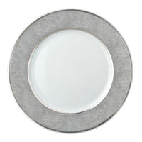 The Bernardaud Sauvage Grey & Platinum plate features a round white center, a snake skin embossed silver-gray border, and shiny platinum trim along the edge. The center is plain and unadorned.
