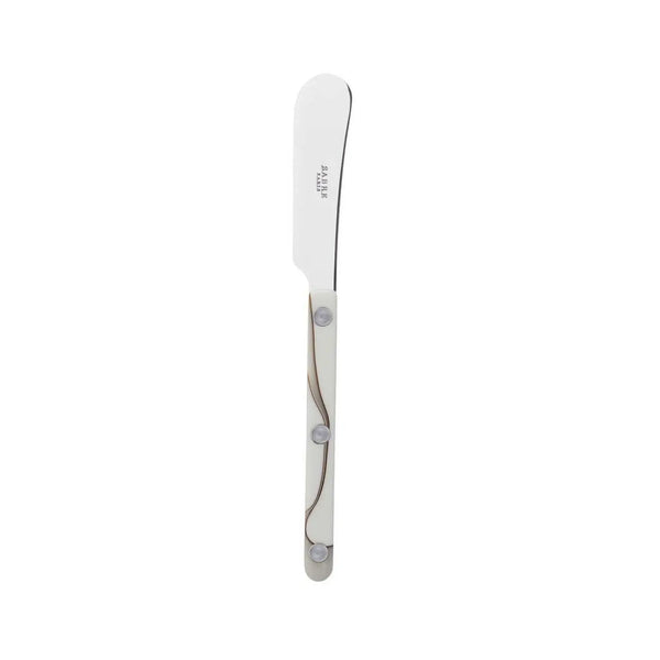 The Sabre Bistrot Dune Butter Spreader Ivory features a rounded tip, stainless steel blade, and an ivory handle with three metal rivets, shown on a plain white background.