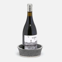 The Angelica Grey Shagreen Wine Coaster by Blue Pheasant features elegant silver detailing and a luxe finish, making it the perfect stylish accent for gifting or entertaining. Set your favorite bottle upright in sophisticated style.