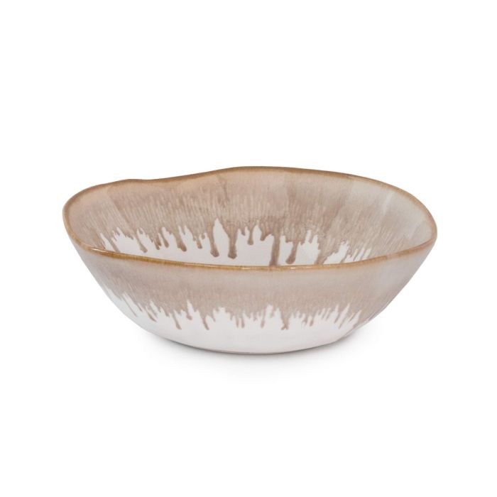 The Burlington Dinnerware Bluff by Simon Pearce is a shallow, round ceramic bowl with a light brown and white dripped glaze along the rim and an organically uneven edge.
