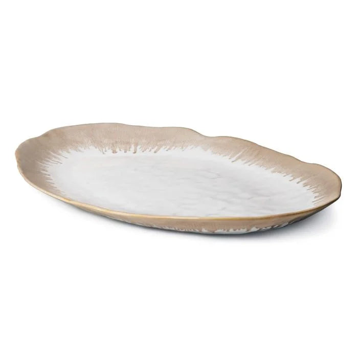 The Simon Pearce Burlington Dinnerware Bluff is a ceramic oval serving platter featuring a wavy rim, beige edge fading to white center, and an organic, rustic look inspired by Burlington dinnerware.